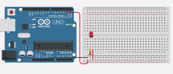 Arduino Uno, dioda LED i rezystor podłączone na płytce stykowej. Schemat połączeń elektrycznych.